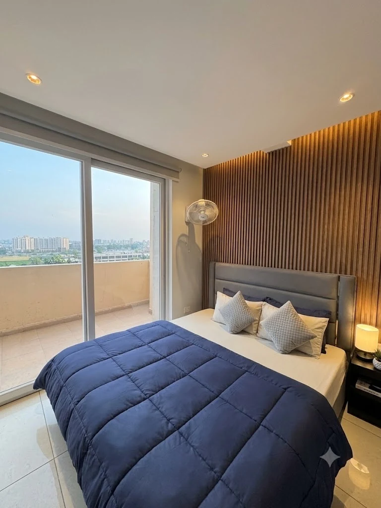 Bedroom with sliding balcony doors and skyline view