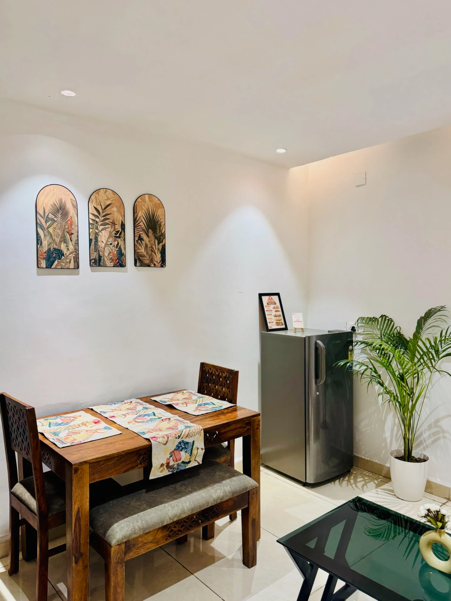 Four-seater dining table with framed botanical art