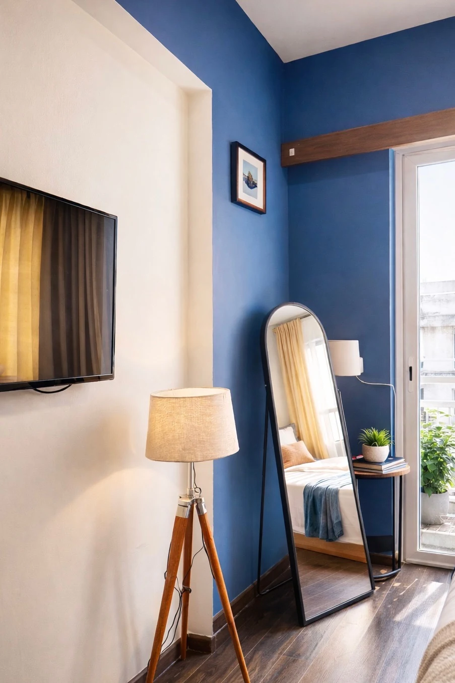 Wall-mounted smart TV, floor mirror and reading lamp