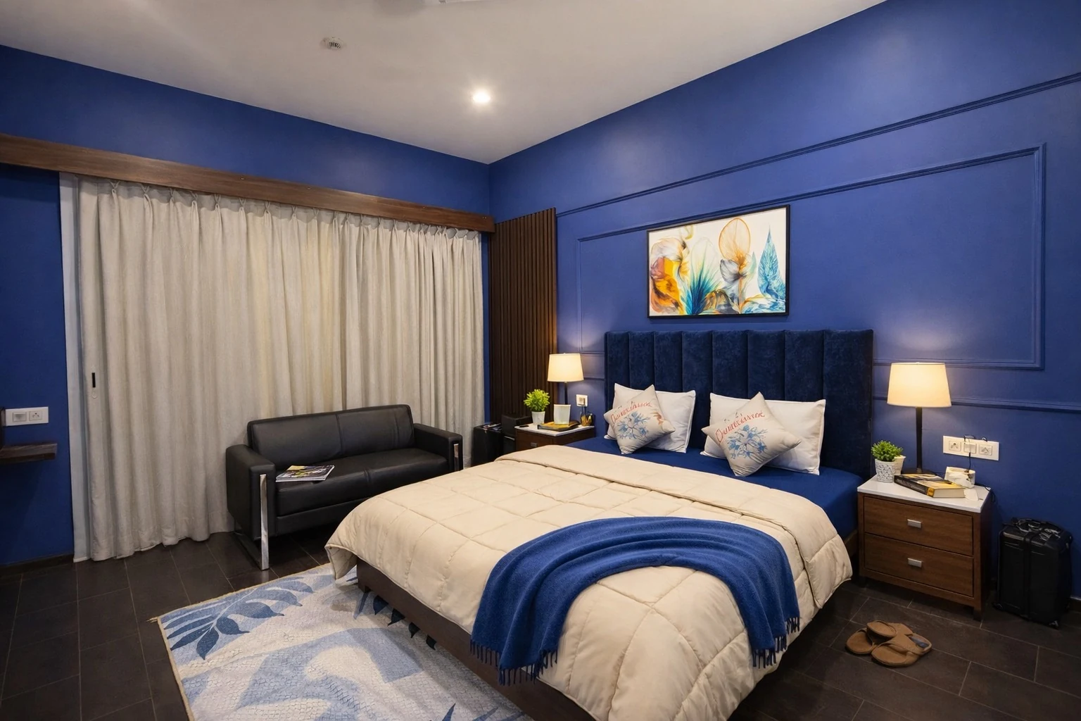 Cobalt blue bedroom with king size bed at Sukoon Cosy Apartment