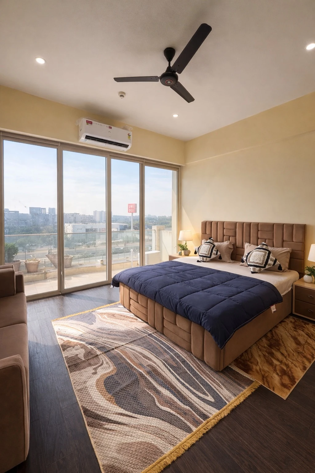 Bedroom with skyline view and warm bedside lighting